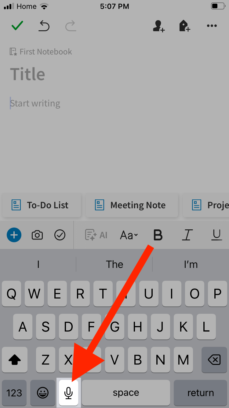 A red arrow pointing to the Dictation key