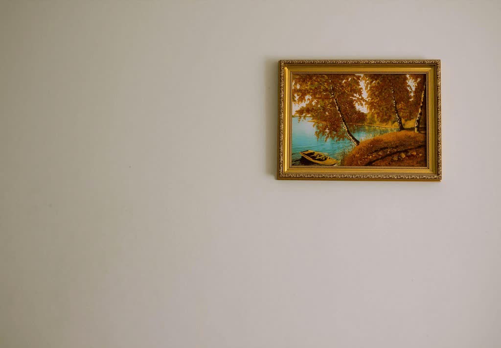 A Single Gold Framed Painting On The Wall