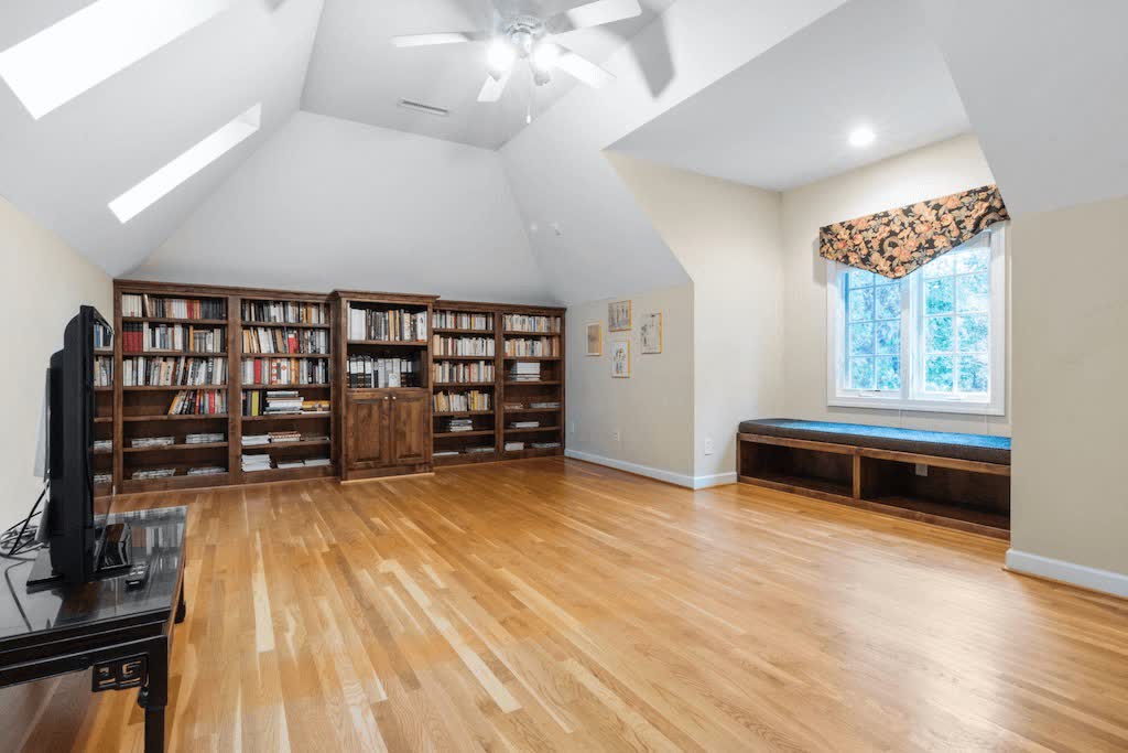 Wooden Bookcase With Books in Empty Room with High Ceilings